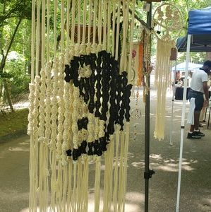 yin yang macrame wall haning on a piece of a nc tobacco stick